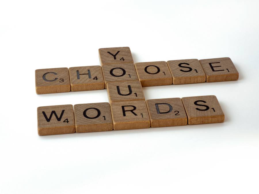 Scrabble tiles spelling CHOOSE YOUR WORDS, representing precise keyword and match type choices in Google Ads